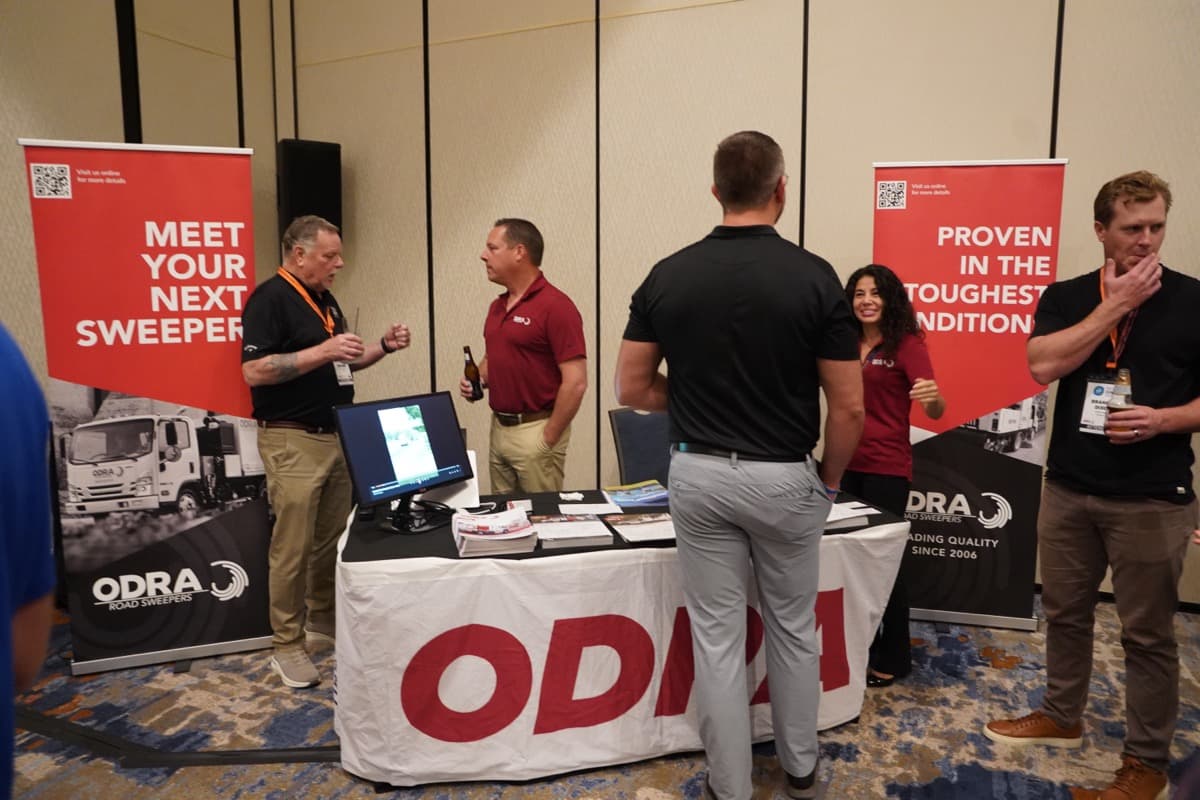 Industry professionals mingling at a vendor display